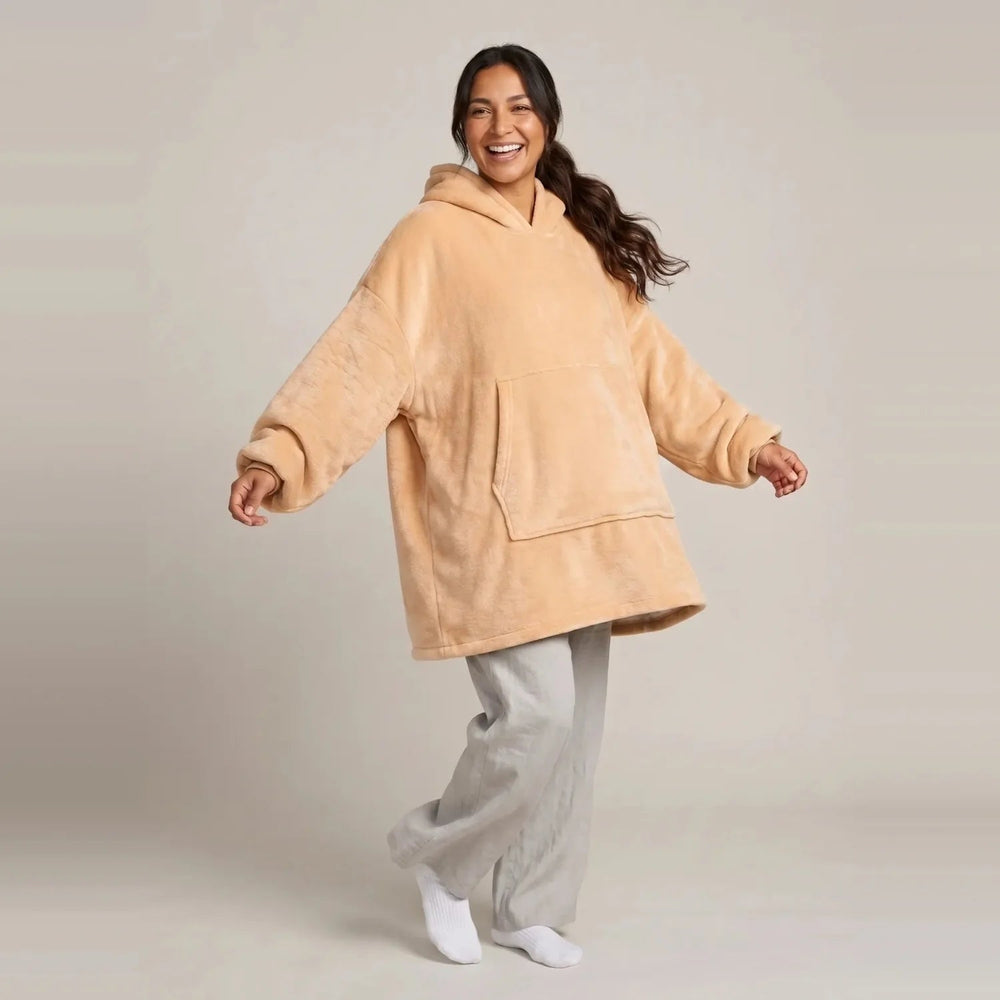 Model wearing the Apricot blanket hoodie, oversized unisex fit, studio photo