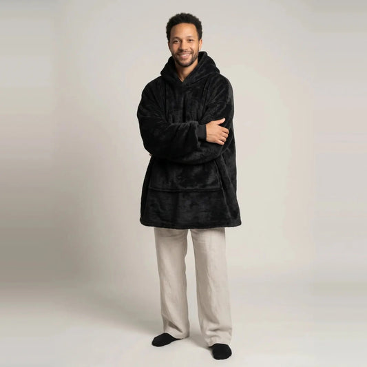 Model wearing the Black blanket hoodie, oversized unisex fit, studio photo
