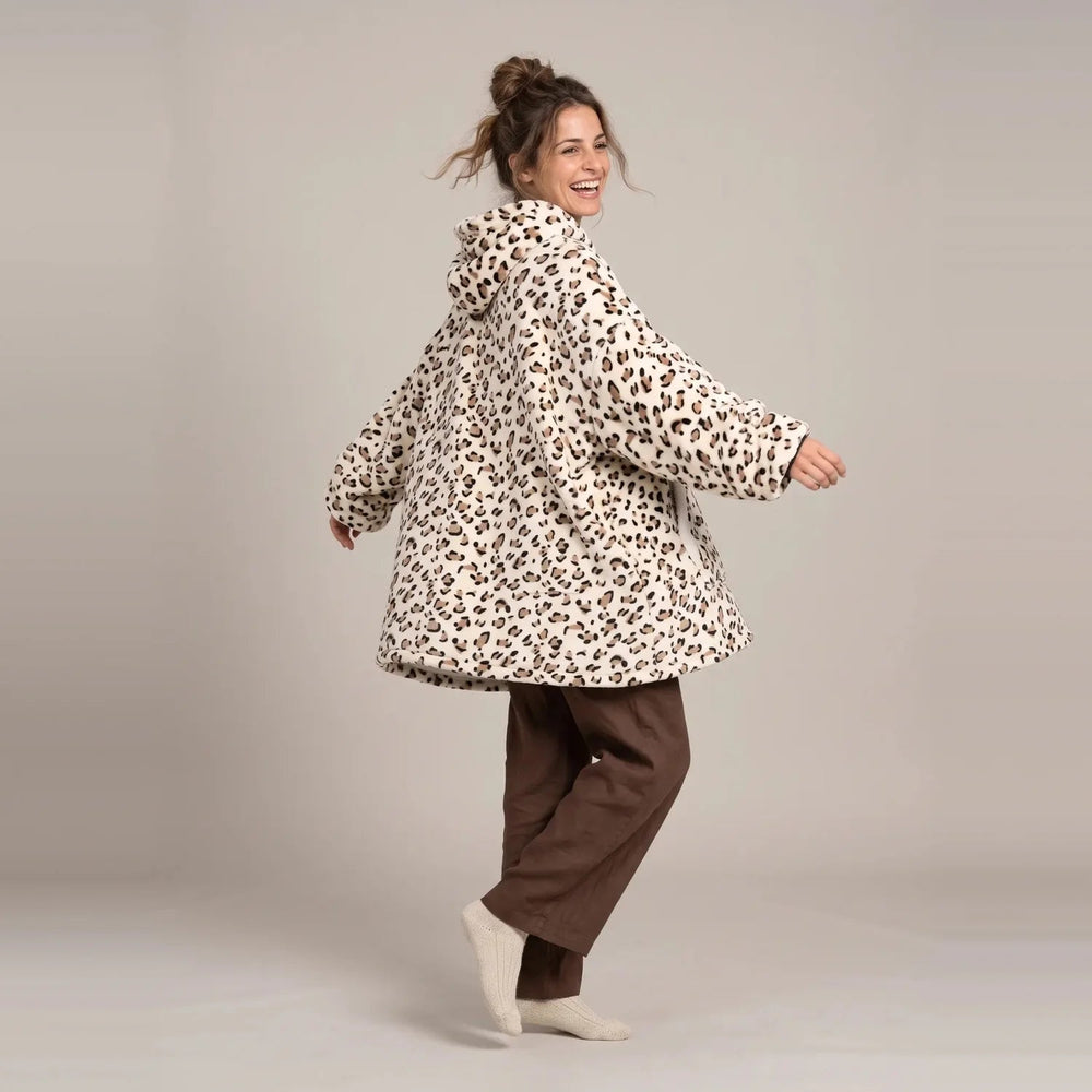 Model wearing the Cream Leopard blanket hoodie, oversized unisex fit, studio photo