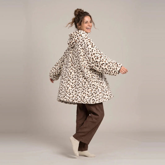 Model wearing the Cream Leopard blanket hoodie, oversized unisex fit, studio photo