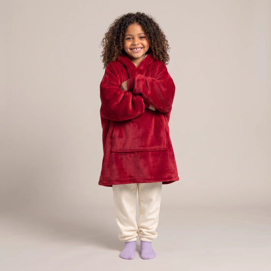 Child wearing the Burgundy Kids blanket hoodie, studio photo