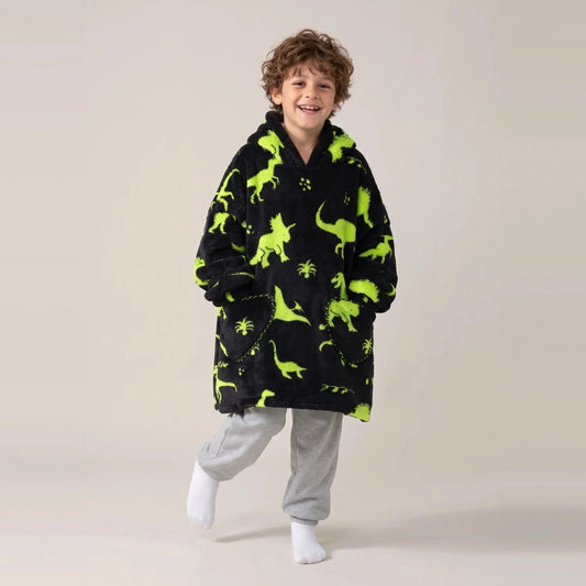 Child wearing the Green Dinos Kids blanket hoodie, studio photo