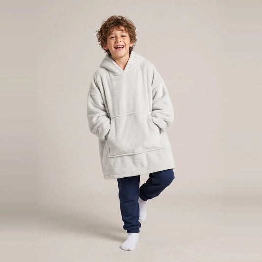 Child wearing the Light Gray Kids blanket hoodie, studio photo