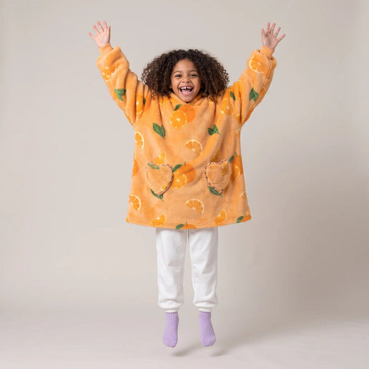 Child wearing the Oranges Kids blanket hoodie, studio photo