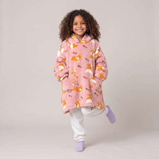 Child wearing the Pink Corgis Kids blanket hoodie, studio photo