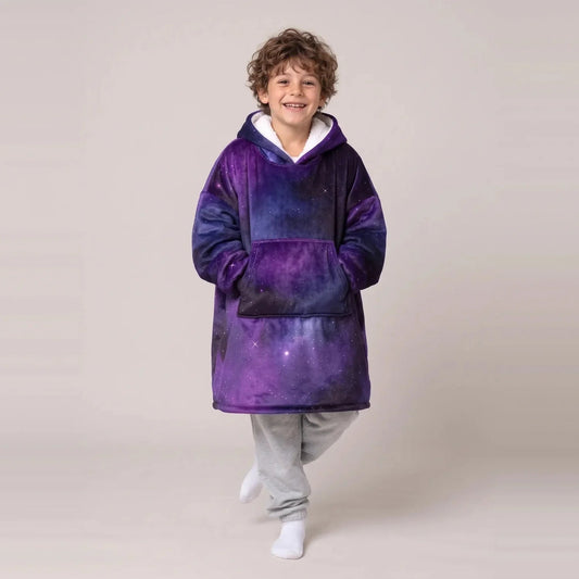 Child wearing the Purple Galaxy Kids blanket hoodie, studio photo