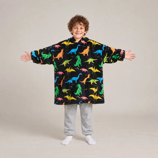 Child wearing the Rainbow Dinos Kids blanket hoodie, studio photo