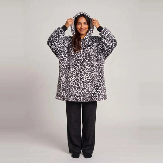 Model wearing the Snow Leopard blanket hoodie, oversized unisex fit, studio photo