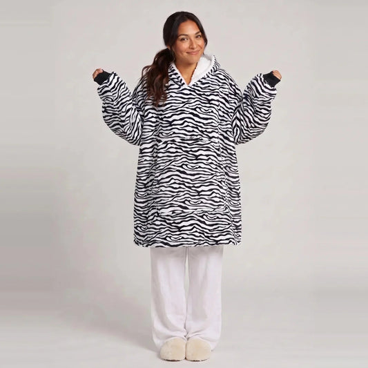 Model wearing the Zebra blanket hoodie, oversized unisex fit, studio photo